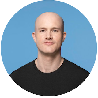 A headshot of Brian Armstrong, Coinbase CEO, smiling in a black tee shirt